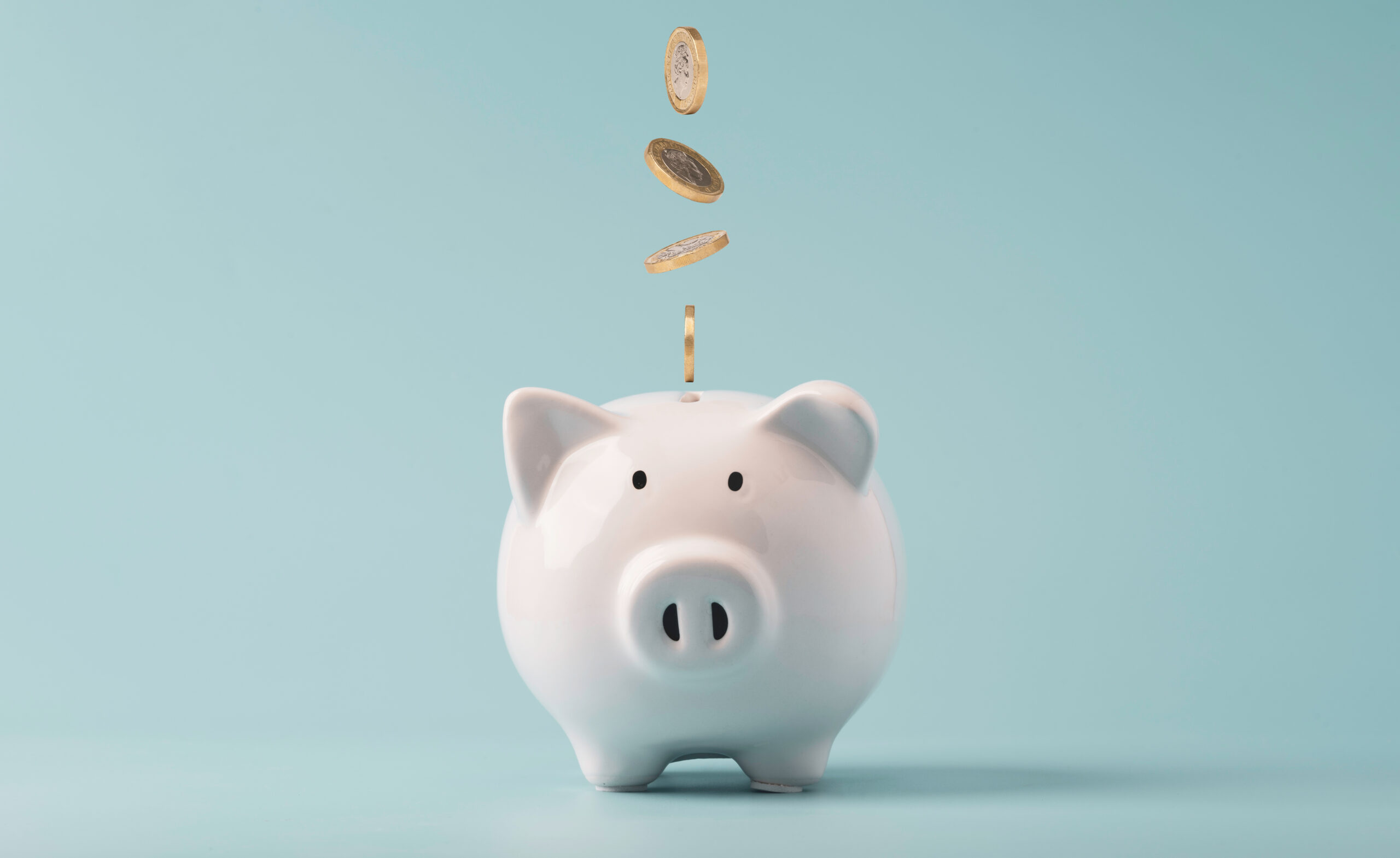 Coins falling to white piggy saving , Financial and money depos